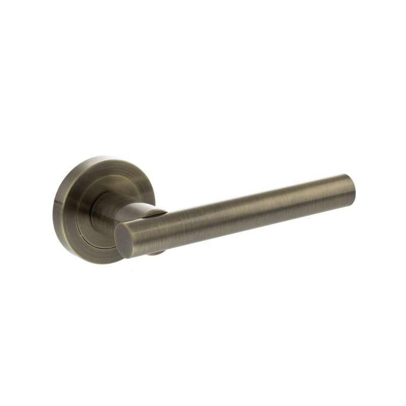 STATUS Nebraska Lever Door Handle on Round Rose - Antique Brass - S28RAB - Choice Handles